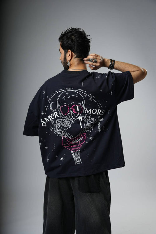 Person wearing a black t-shirt with a graphic design on the back .