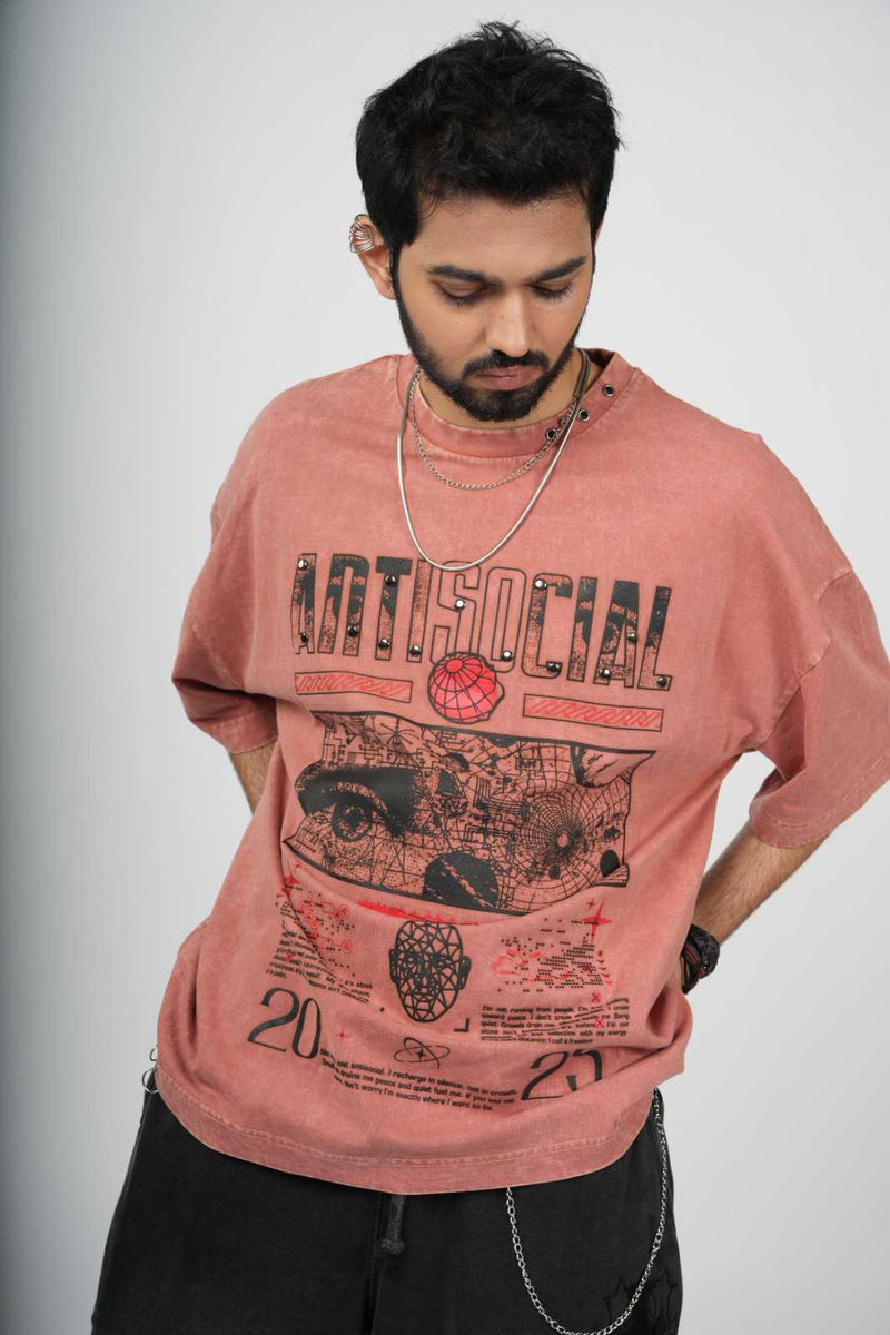 Man wearing a pink t-shirt with graphic design and text on a plain background