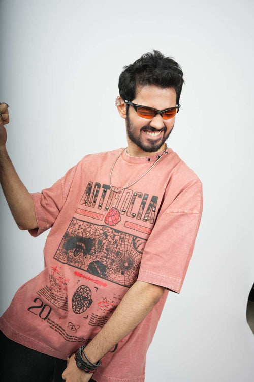 Man wearing a pink graphic t-shirt and sunglasses on a white background