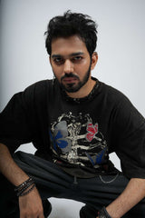 Man wearing a black t-shirt with butterfly design on a white background