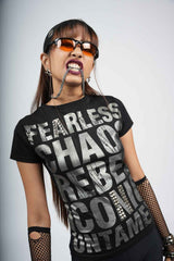 Person wearing a black t-shirt with text, sunglasses, and fishnet gloves on a plain background