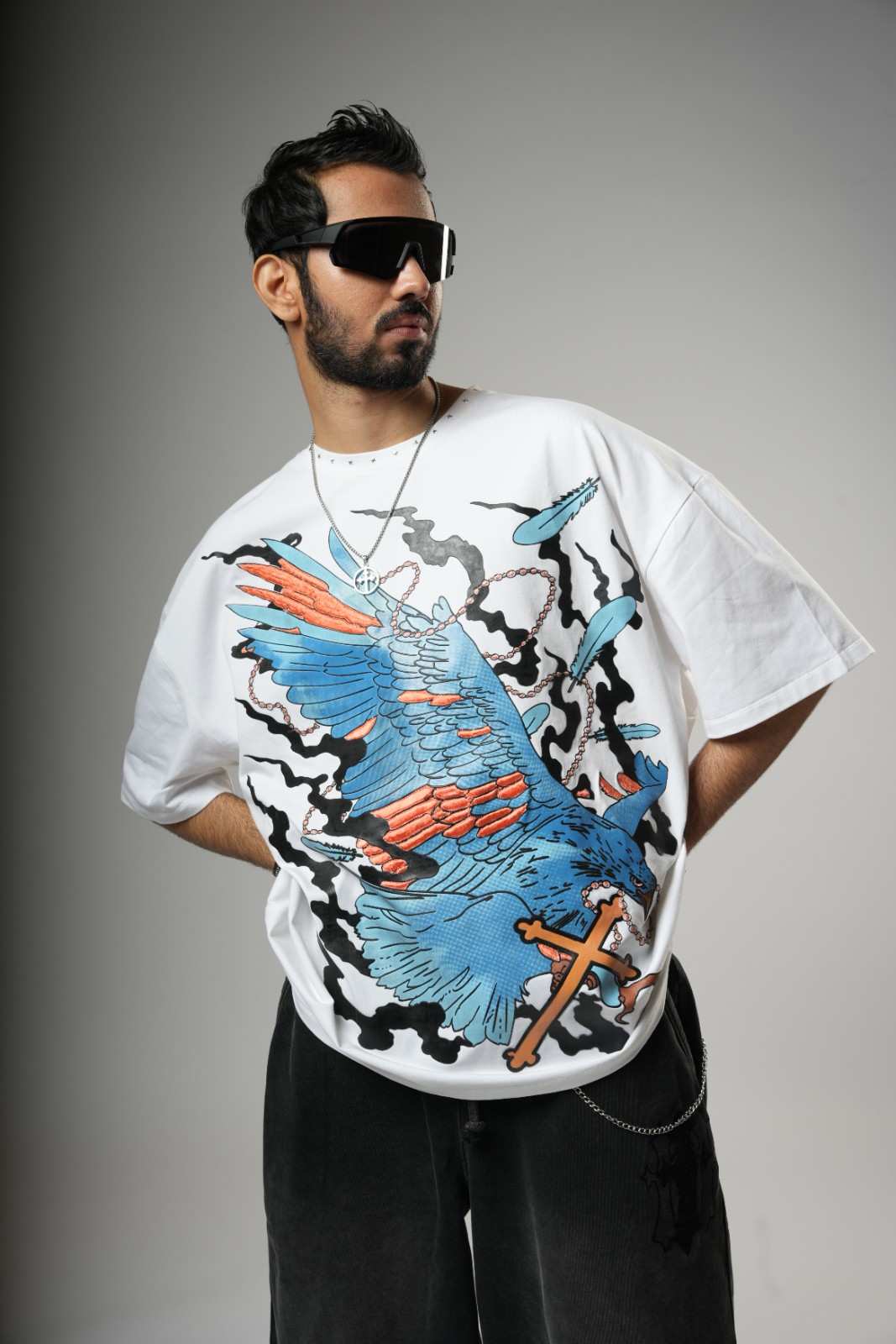 Man wearing a white t-shirt with a colorful graphic design 