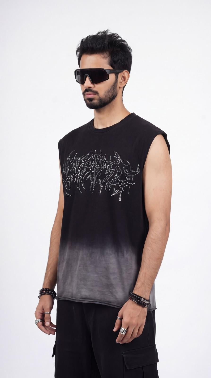 Man wearing a black sleeveless shirt with white graphics on a white background