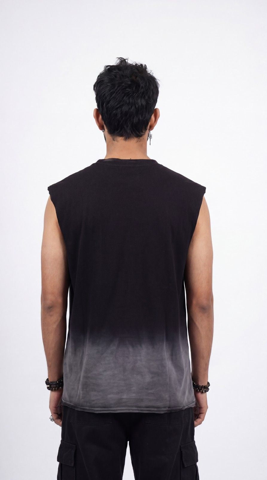 Person wearing a black sleeveless shirt with gradient design on a white background